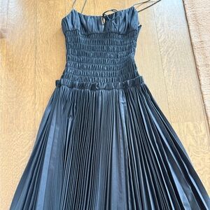 KHAITE Black Pleated Midi Dress with Smocked Bodice and Spaghetti Straps